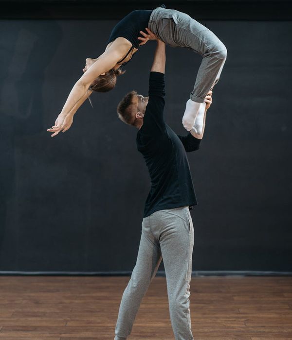 Man performing a controlled strength exercise in a bright, modern studio.